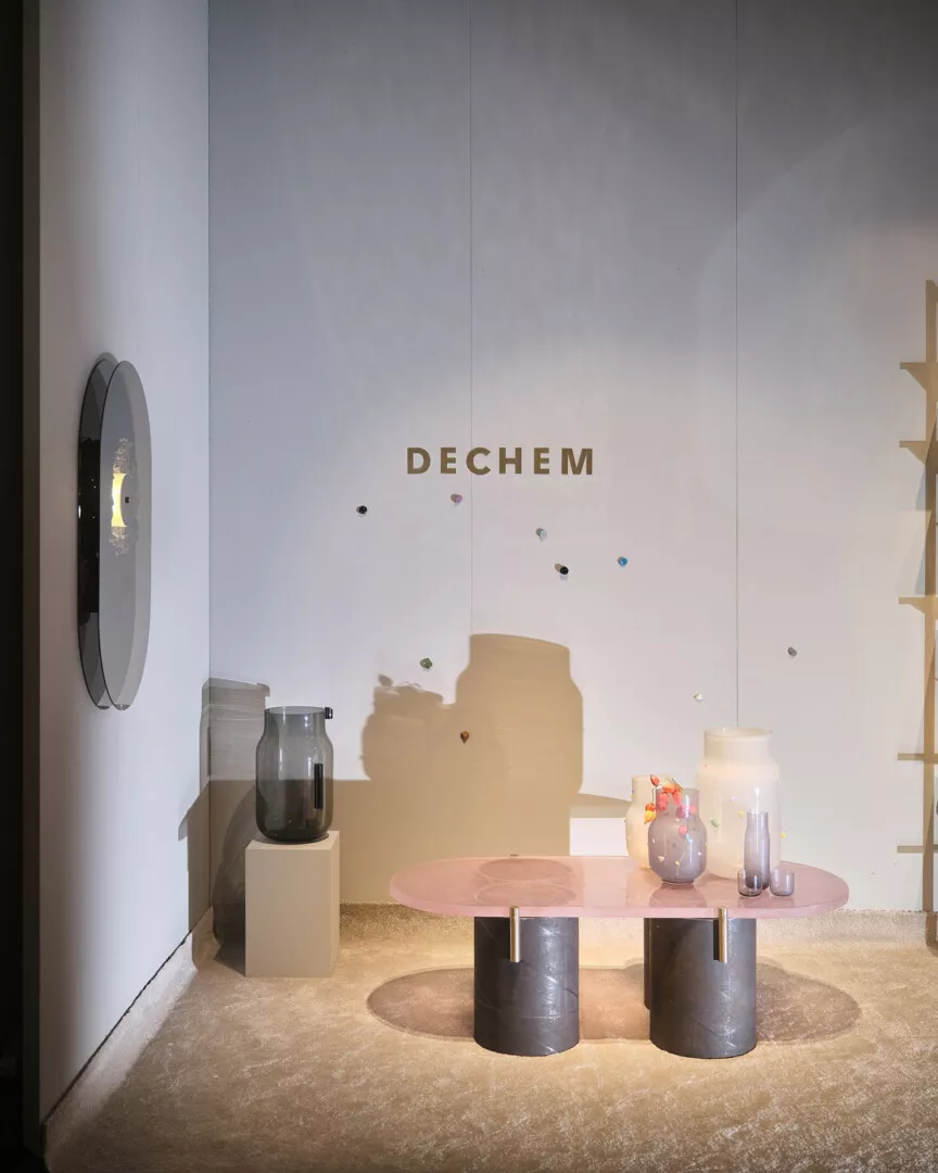 Minimalist showroom interior with modern furniture and glass decor.