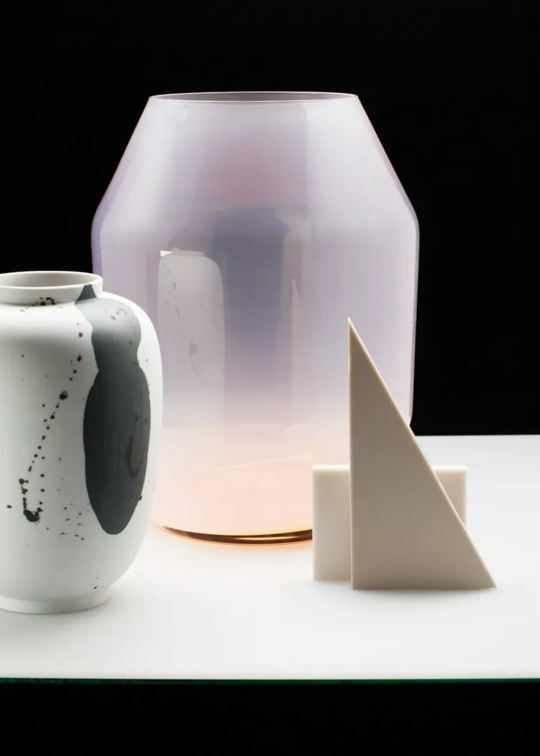 Modern ceramic art pieces against black and white backdrop.