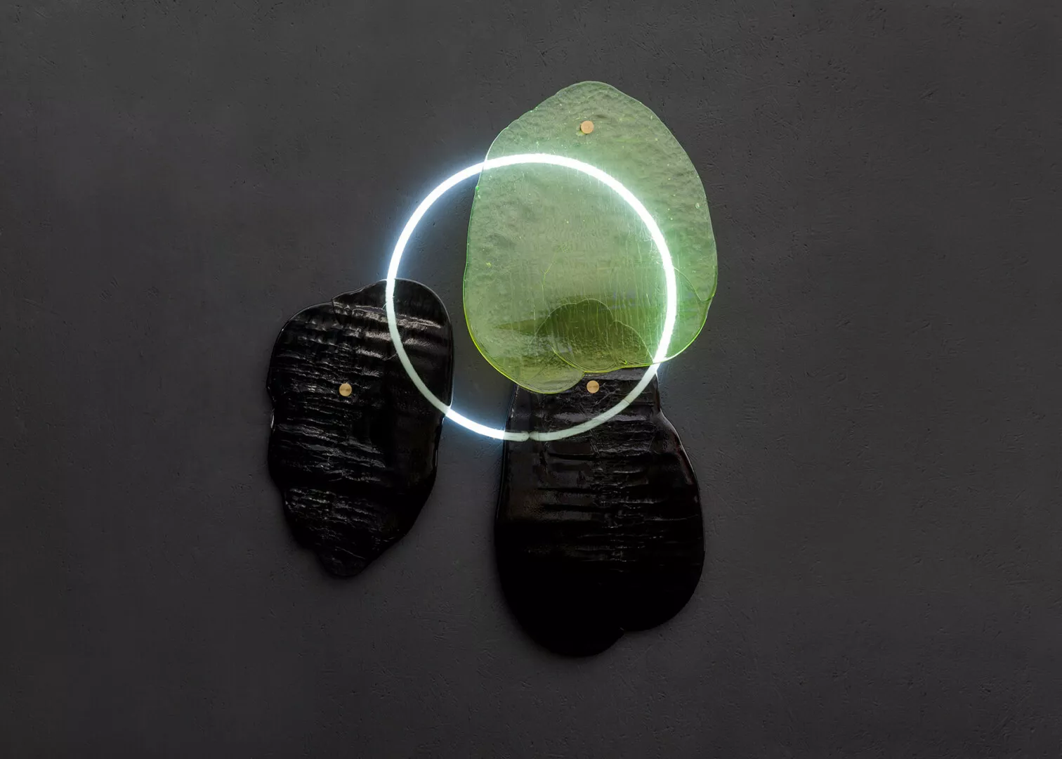 Abstract glass art with illuminated circular elements.