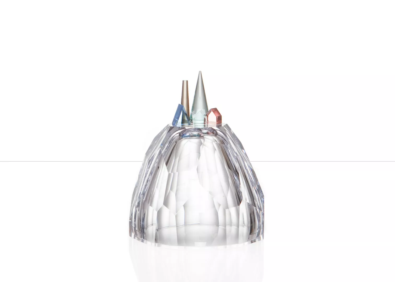 Crystal pencil holder with colored tips on white background.