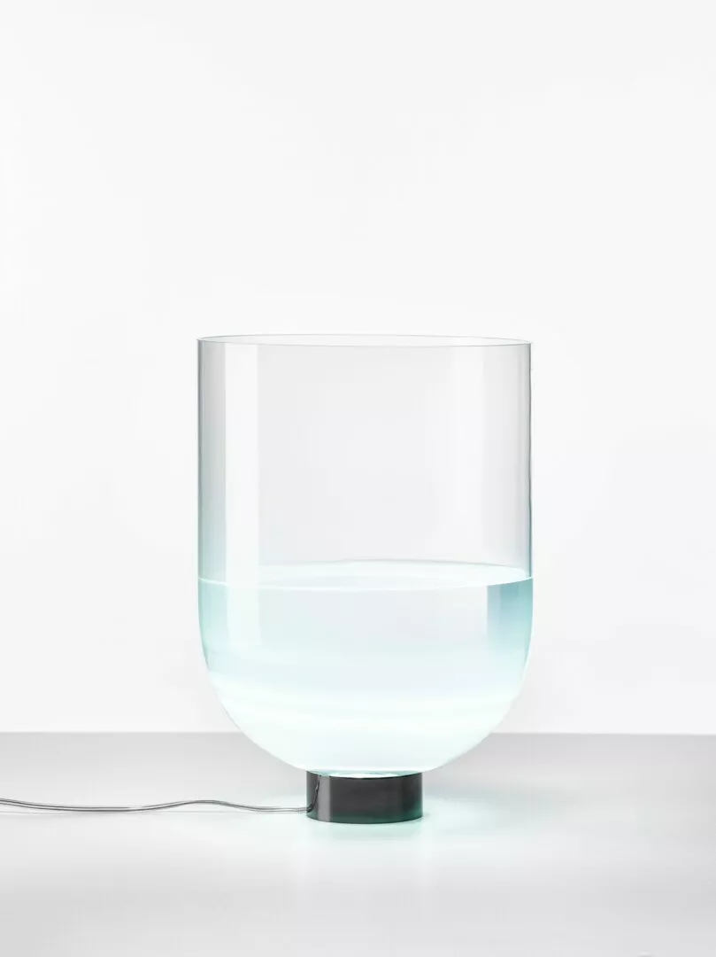 Clear glass LED lamp partially filled with water.