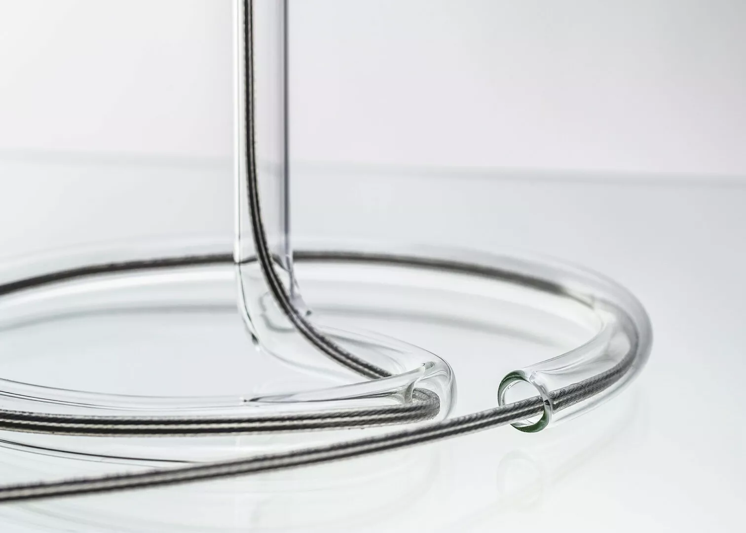 Clear glass tubing on white background.