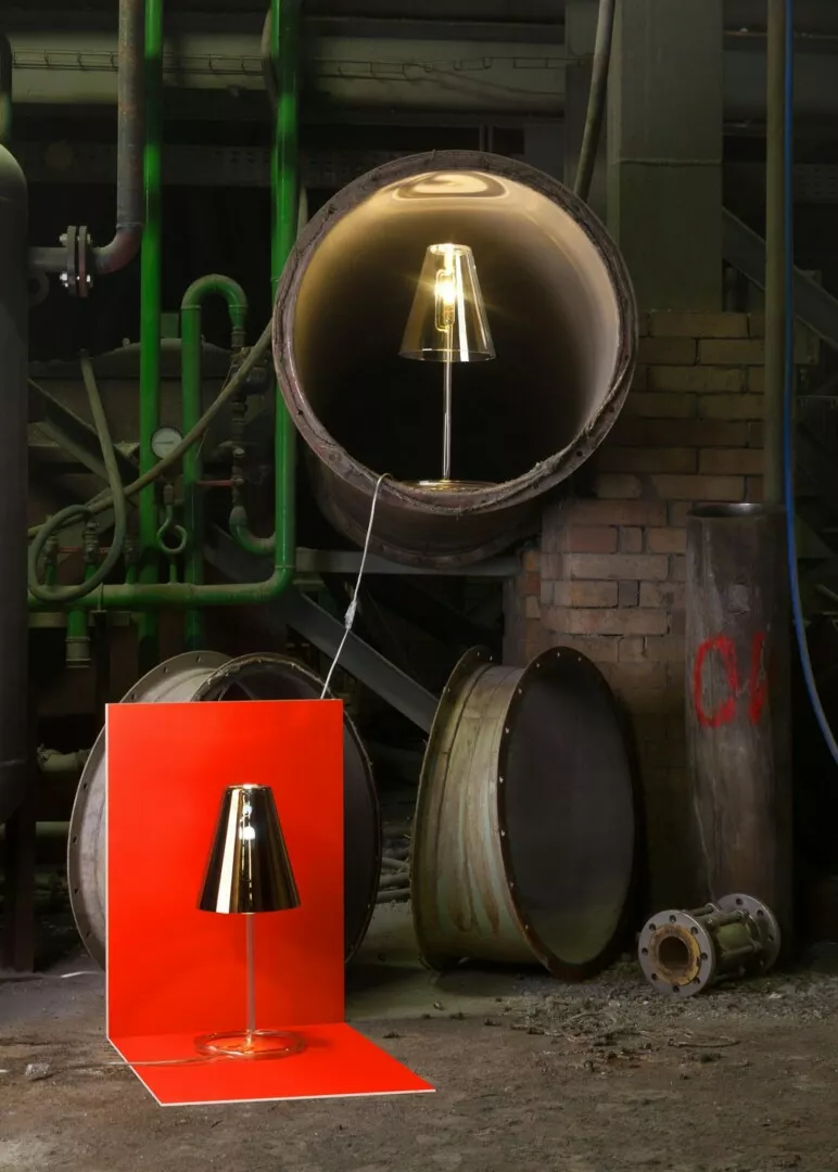 Lamps displayed in a gritty industrial setting.