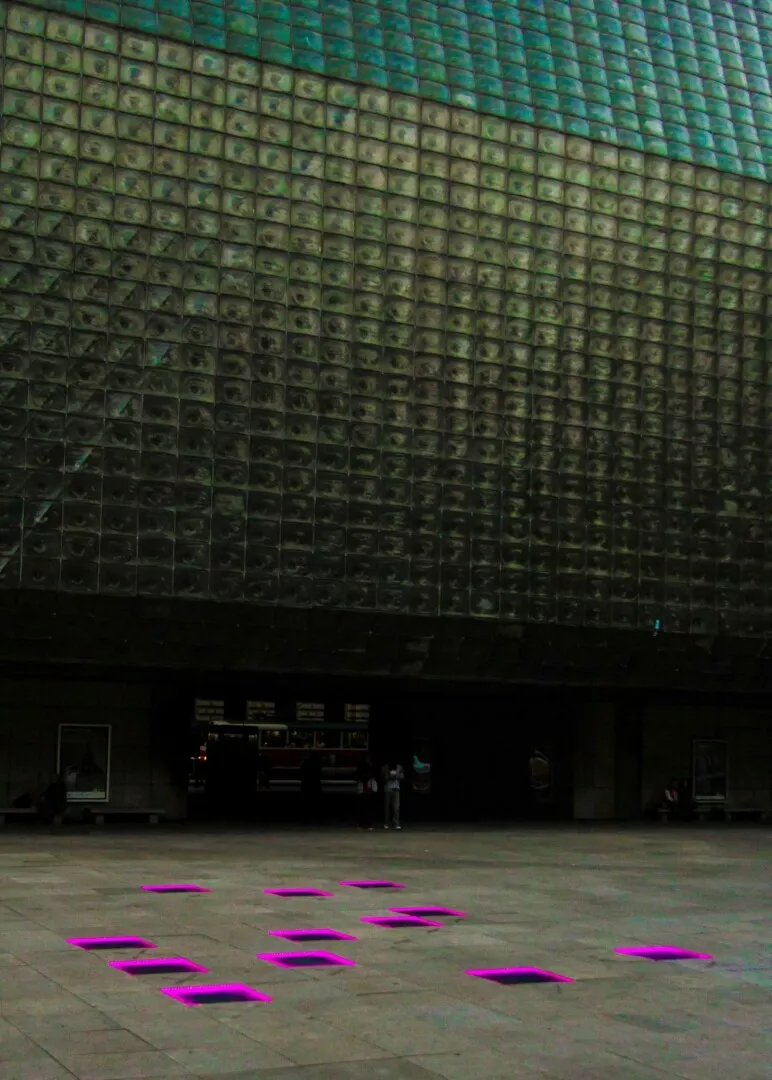 Facade with twinkling glass tiles, magenta floor lights.