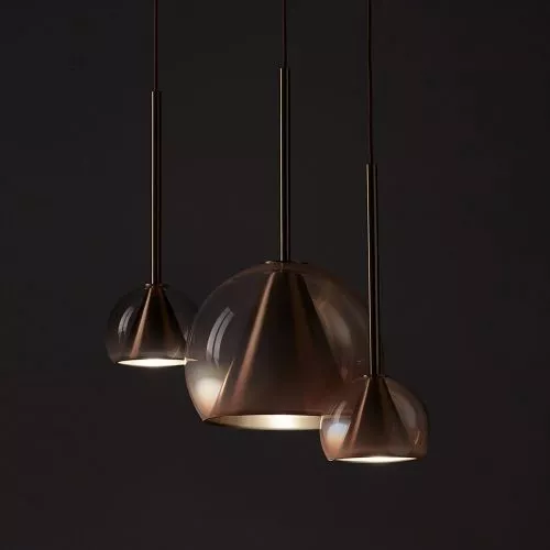 Three modern pendant lights with a bronze finish.