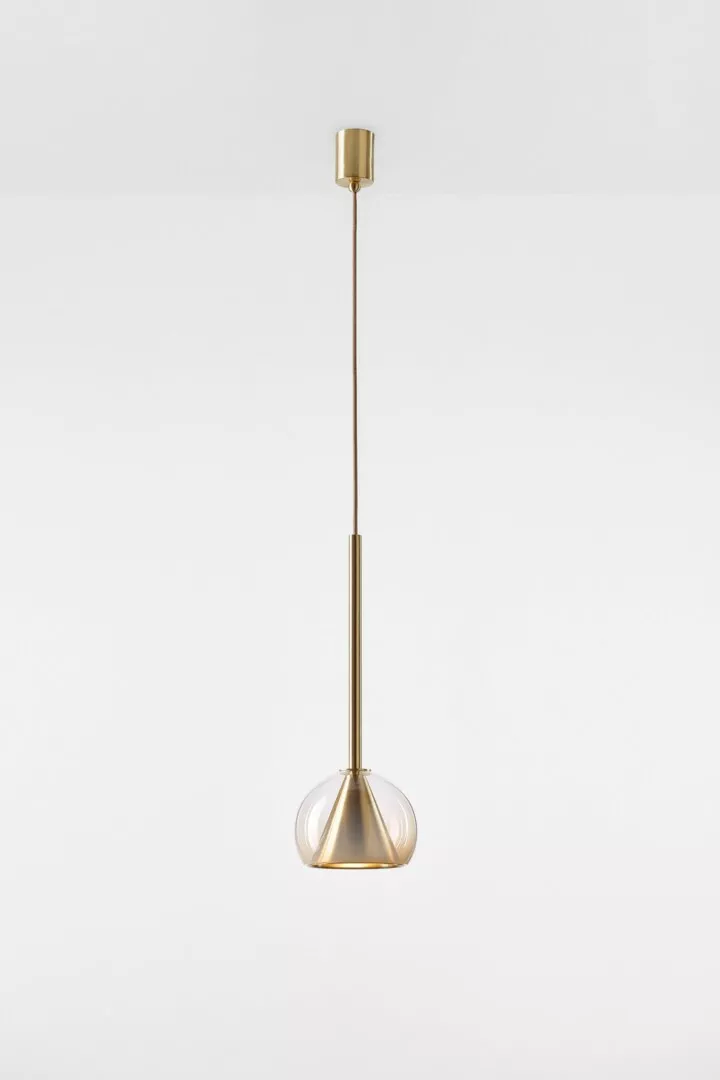 Minimalist gold pendant light on white background.