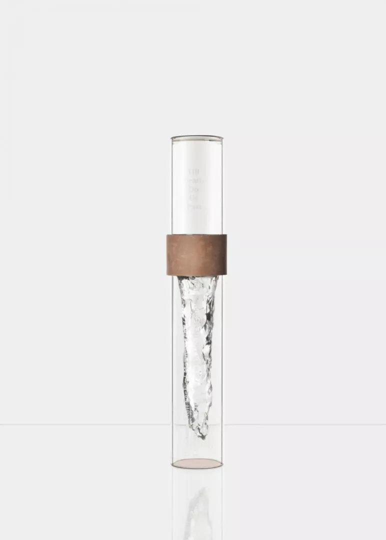Clear glass cylinder with ice core and brown band.