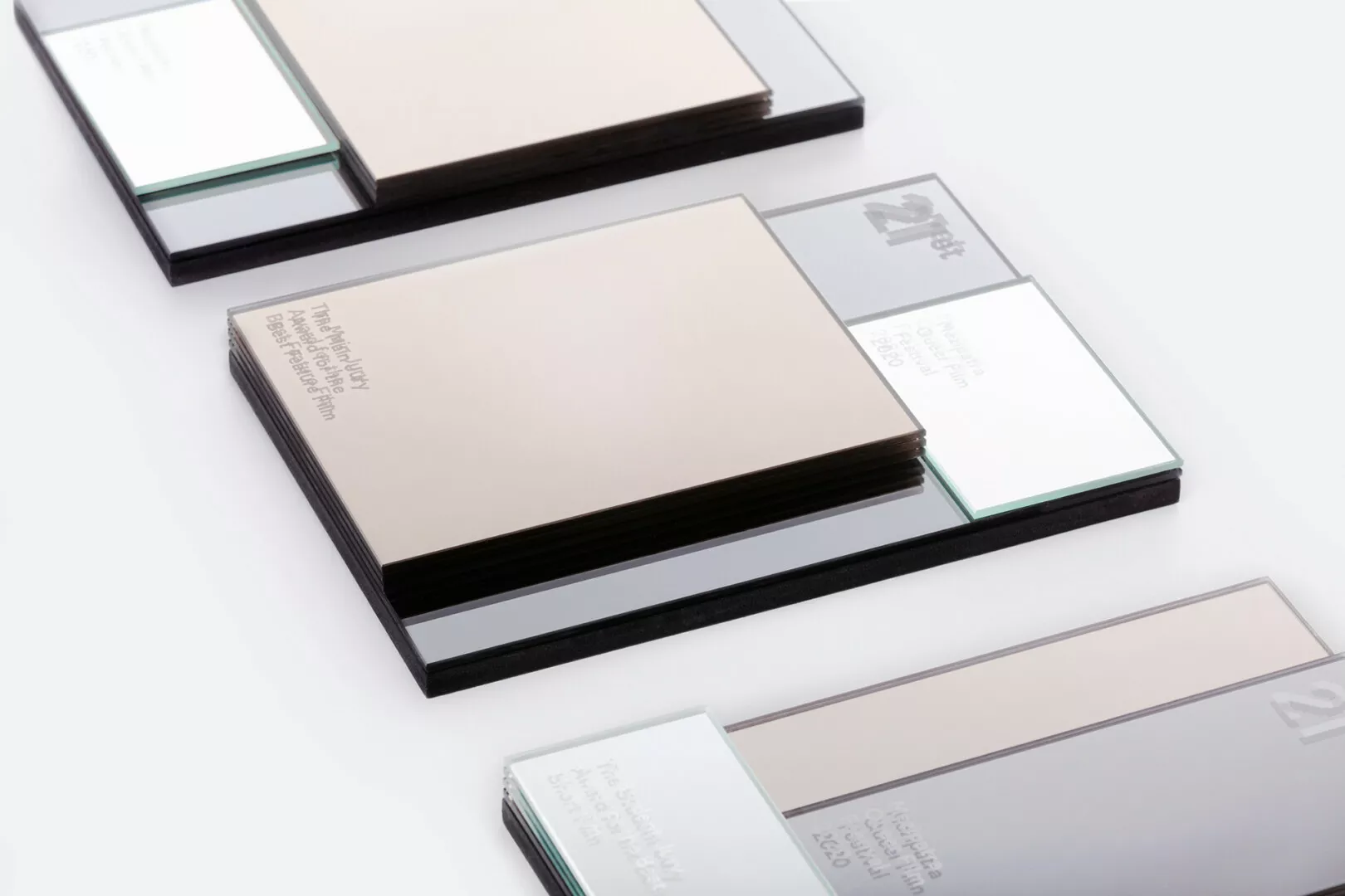 Stacked business cards on reflective glass surfaces.