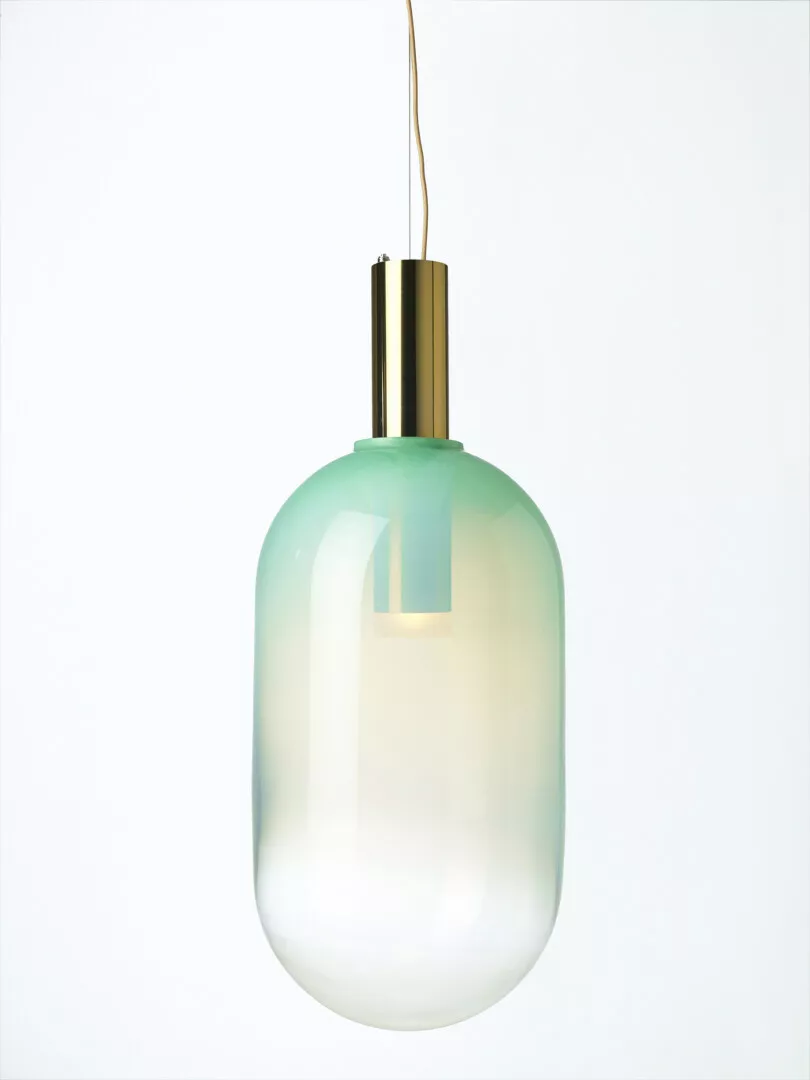 Minimalist green ombre pendant light on white background