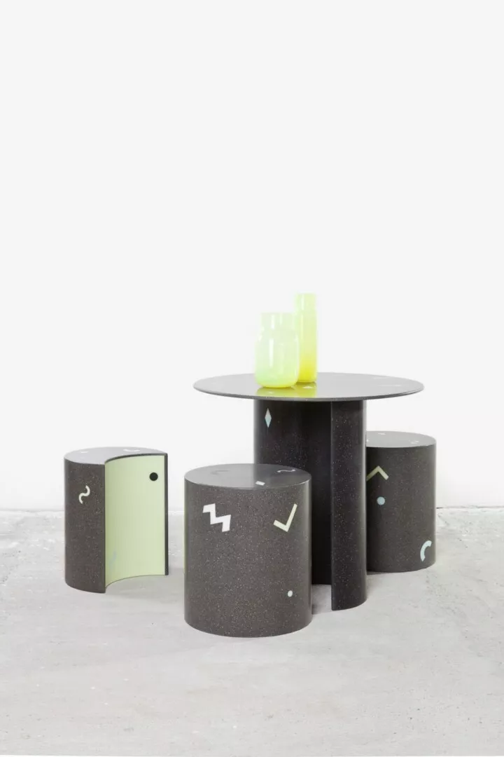 Modern stools and table with yellow glass decor.