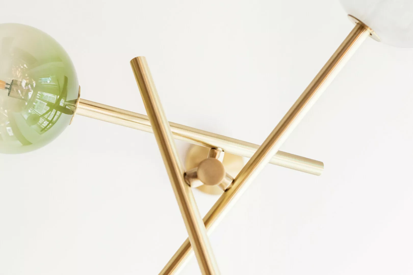 Modern gold chandelier with clear globe light.