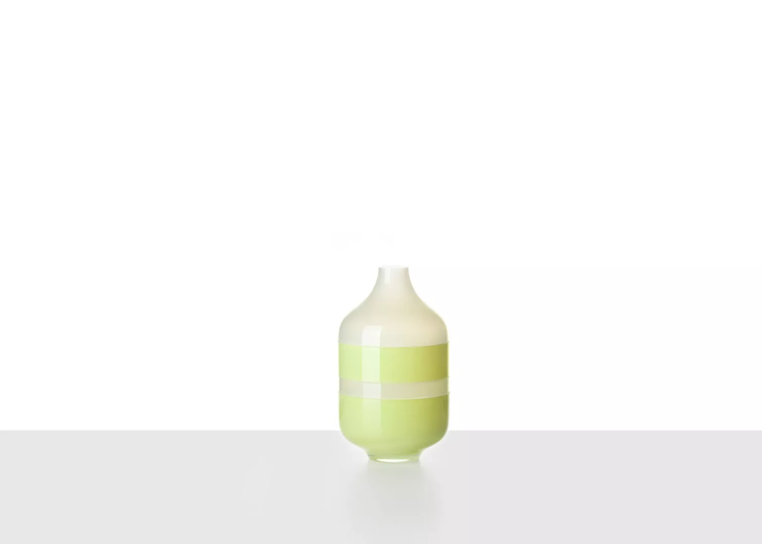 Minimalist green striped vase on white background