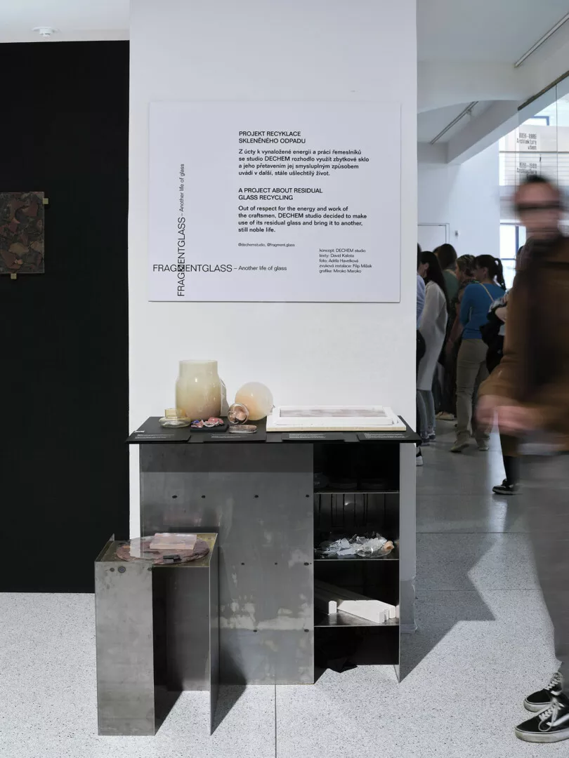 Exhibit on glass recycling with informational display and objects.
