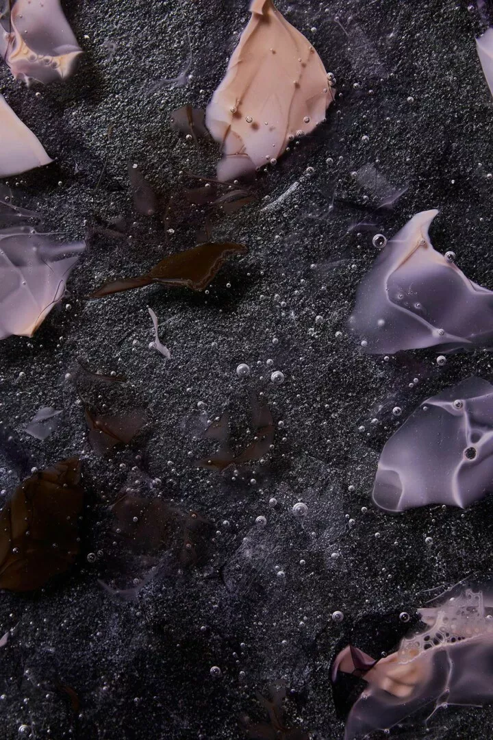 Abstract icy bubbles and translucent shards on black.