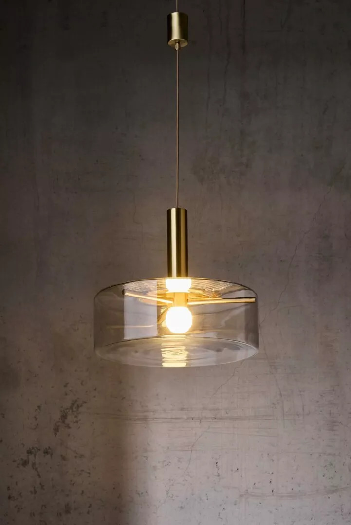 Modern pendant light with brass finish and clear shade.