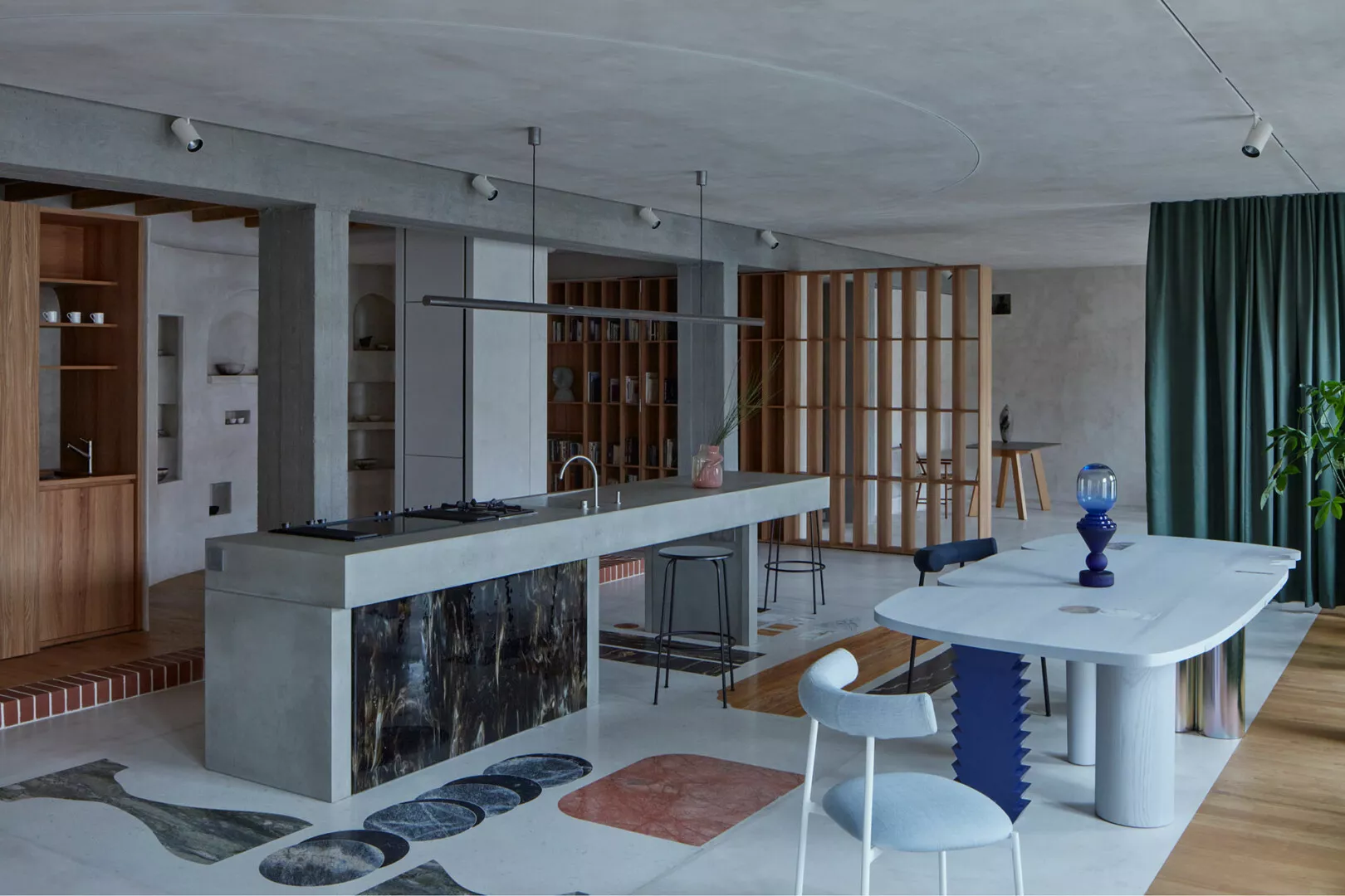 Modern open-plan kitchen with eclectic furniture and design elements.